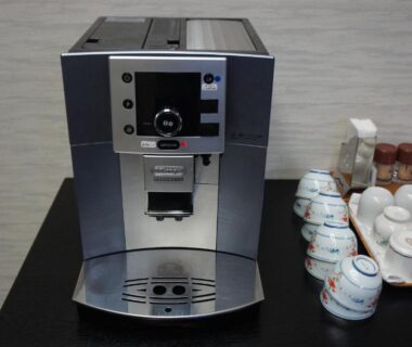Automatic coffee machine with stacked ceramic teacups on Sumiyoshiya counter in Ishikawa