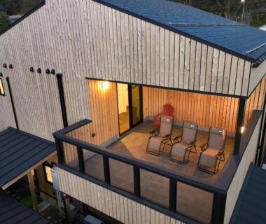 Wooden balcony with reclining chairs at Sumiyoshiya ryokan in Chubu, Niigata, Japan