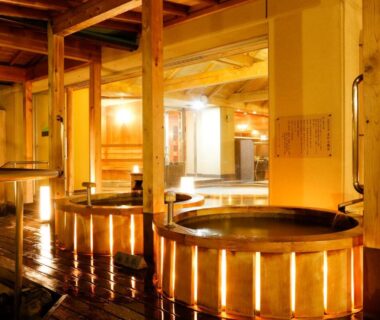 Indoor wooden baths with warm lighting at Sun Urashima Yuki no Sato in Mie, Kansai