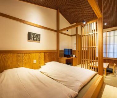 Traditional tatami room with twin futon bedding, shoji screens, wooden lattice partition and low dining area Susukinohara Ichinoyu Kanagawa