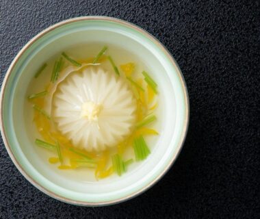 Clear broth with chrysanthemum-shaped garnish at Suwa Grand Shrine Kameya Inn, Nagano, Chūbu