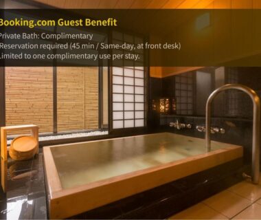 Indoor wooden soaking tub, shoji screens, seating and tiled floor in Suwa Grand Shrine Kameya Inn bathing room, Nagano