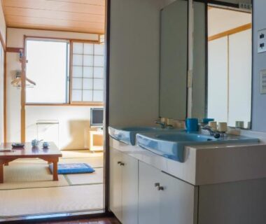 Washbasin area opens to a tatami room with low table and shoji screens at Suzukisou in Kyoto