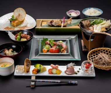 Assorted Japanese dishes and bowls arranged for a multi-course ryokan meal at Suzuranso in Nagano