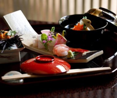 Lacquer trays with assorted Japanese dishes at TAKITEI Riverside Onsen in Kanazawa, Ishikawa