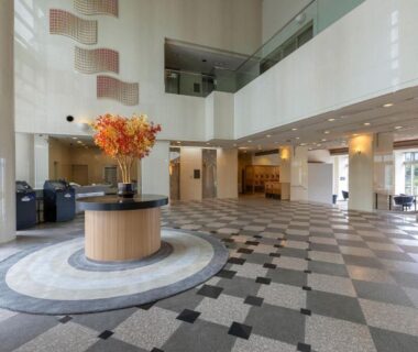 High-ceiling ryokan lobby with tiled floor, central floral arrangement and seating at TAOYA Gero in Chūbu, Gifu