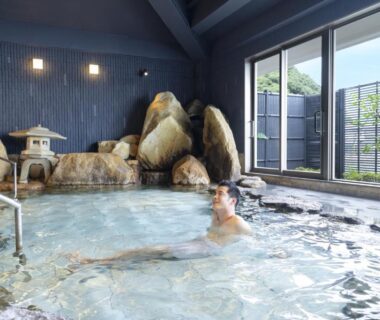 Guest soaking in indoor rock onsen at TAOYA Nachikatsuura in Wakayama, Kansai