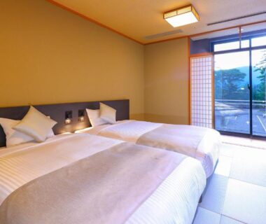Tatami room with twin beds and shoji doors overlooking garden at TAOYA Nasu Shiobara, Tochigi, Kantō, Japan