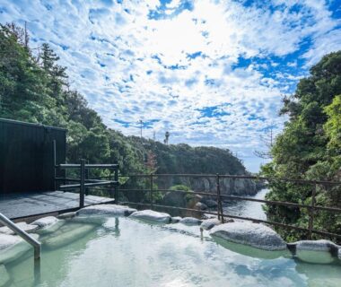 Outdoor hot spring bath on terrace overlooking forested ravine at TAOYA Shirahama Senjyo, Wakayama