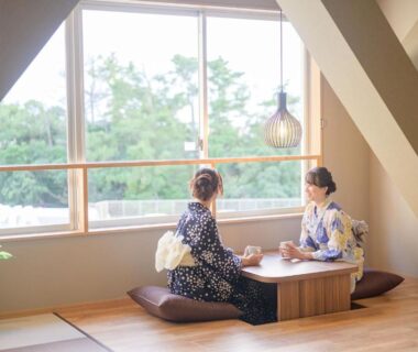 Two guests in traditional robes seated at low tatami table by window, TAOYA Shirahama Senjyo, Wakayama
