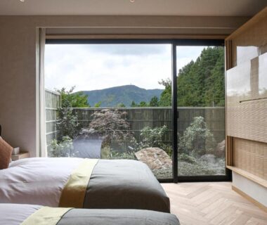 Two beds facing glass doors opening to garden and mountain views at THE HIRAMATSU SENGOKUHARA HAKONE, Kanagawa