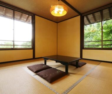Tatami room with low table and floor cushions at Tabinoyado Asonoyu, Kumamoto, Kyūshū