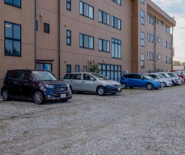 Gravel parking lot with parked cars at Tabist Daibou Ichihara in Chiba, Kantō