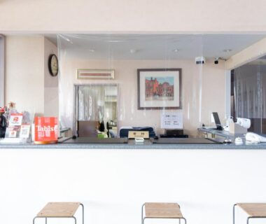Bright reception counter with stools and clear protective screen at Tabist Daibou Ichihara Mens Only, Chiba