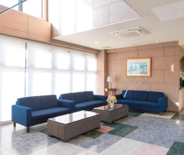 Sunlit lobby seating with blue sofas at Tabist Daibou Ichihara, Chiba Kantō