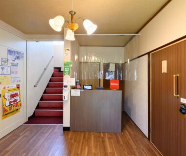 Reception area with desk, staircase and wooden flooring at Tabist Hamanako no Yado Kosai, Chūbu Shizuoka Japan