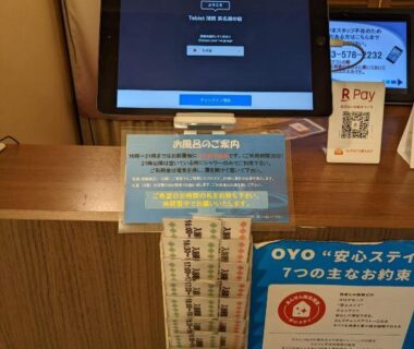 Tablet check-in kiosk on wooden counter with brochures, Tabist Hamanako no Yado Kosai, Shizuoka
