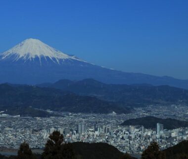 Mount Fuji rising above city skyline viewed from Tabist Hotel Seishokan in Shizuoka, Chūbu, Japan
