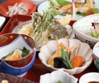 Trays of seasonal small plates, tempura and simmered vegetables at Tabist Koboshi no Yu Senshintei, Aizu, Fukushima