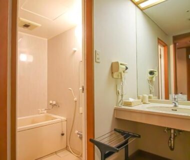 Bathroom with bathtub, sink vanity, mirror and stool at Tagawa Ryusenkaku, Ishikawa, Chūbu Japan