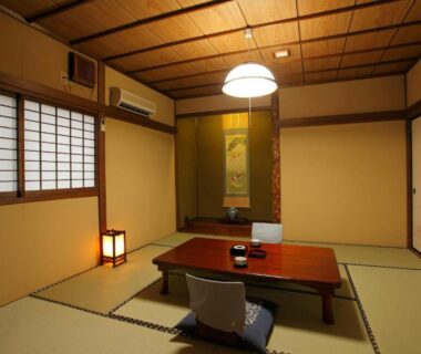 Traditional tatami room with low wooden table, zabuton cushions, shoji screens and tokonoma alcove at Tagoto, Fukushima