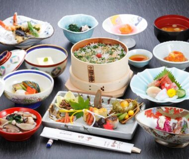 Assorted traditional Japanese plates including sashimi, steamed basket, soups and side dishes at Tagoto, Fukushima