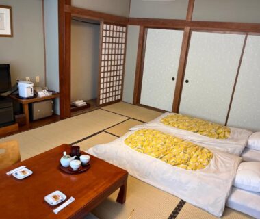 Tatami room with futons, low table and tea set at Taiheikan in Yamanashi, Chūbu