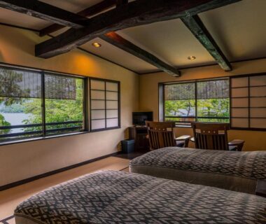 Two beds on tatami, low table and shoji screens, windows overlooking garden at Taikyourou in Kyoto Kansai
