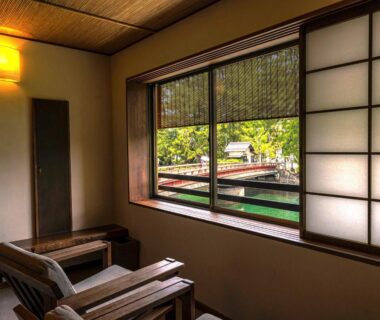 Tatami room with wooden chairs and shoji screens at Taikyourou in Kyoto