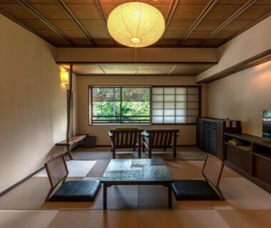 Traditional tatami room with low table, floor cushions, shoji screens and garden view at Taikyourou in Kyoto, Kansai