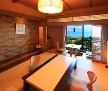 Traditional tatami room with low table and balcony overlooking water at Taiseikan, Shizuoka, Chūbu, Japan