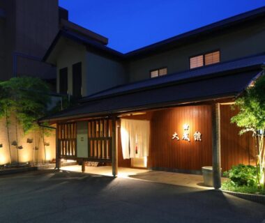 Illuminated wooden entrance and lit pathway at Taiseikan ryokan in Shizuoka prefecture