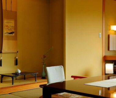 Traditional tatami room with low table, alcove and chair at Taishoya in Saga, Kyushu