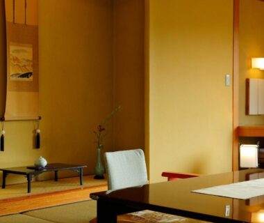 Tatami room interior with low table, tokonoma alcove, chair and lamp at Taishoya in Saga, Kyushu, Japan