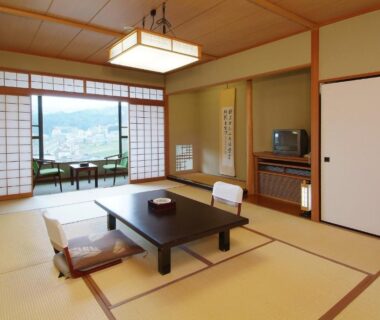 Traditional tatami room at Takahan with low table, floor chairs and shoji screens overlooking Niigata