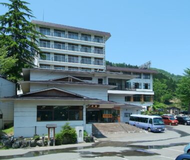 Exterior of Takahan with parking lot and mountain backdrop in Niigata, Chūbu Japan