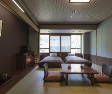 Tatami room with low table, zabuton cushions and shoji screens at Takamiya Bettei Kuon in Yamagata Tōhoku