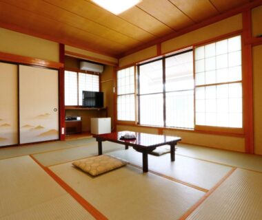 Traditional tatami room with low table, zabuton cushion, shoji screens and sliding fusuma at Takanoya Niigata