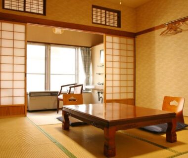 Tatami room with low table, shoji screens and seating at Takasagoya Ryokan in Yamagata, Tōhoku, Japan