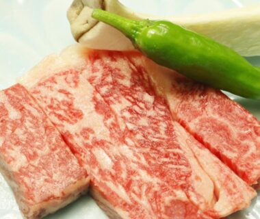 Marbled beef slices with green pepper and mushroom on plate at Takasagoya Ryokan Yamagata