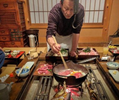 Cooking over irori hearth in tatami dining room at Takimi Onsen Inn, Nagano
