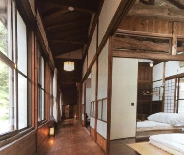 Wooden corridor with shoji and tatami room visible at Takimi Onsen Inn in Nagano, Chūbu Japan