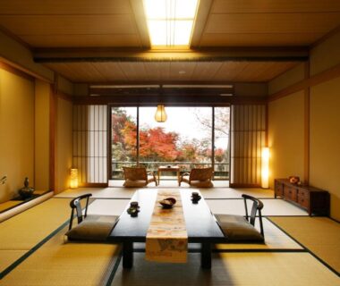 Traditional tatami room with low dining table, floor cushions and garden view at Takimotokan Yuki No Sato, Gifu