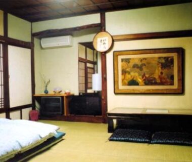 Traditional tatami room with futon bedding, shoji screens and low seating at Tama Ryokan in Tokyo