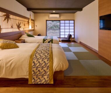 Tatami area with twin Western beds, shoji screen and low seating at Tamana Onsen Happouen in Kumamoto, Kyushu