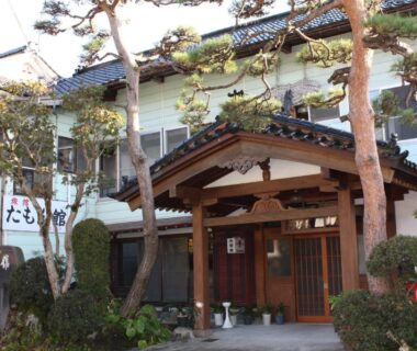 Wooden entrance with pine trees at Tamonkan in Yamagata