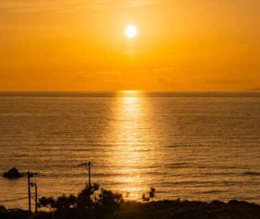 Golden sunset over calm sea near Tanoura Onsen Kaikatei Kawai on Niigata coast