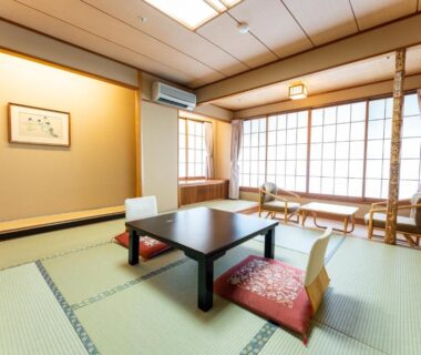 Bright tatami room with low table, zabuton cushions and shoji screens at Tateshina Grand Hotel Takinoyu in Nagano