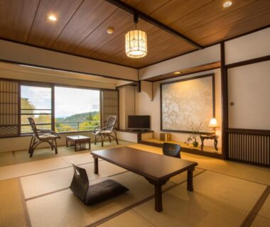 Traditional tatami room with low table, zabuton cushions, shoji screens and seating overlooking hills at Tateshina Shinyu Onsen, Nagano