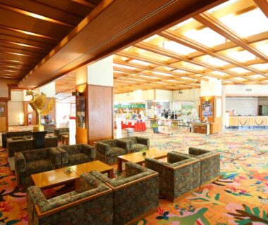 Lobby with patterned carpet, wooden ceiling and lounge seating at Tateyama Prince Hotel Nagano Chūbu Japan
